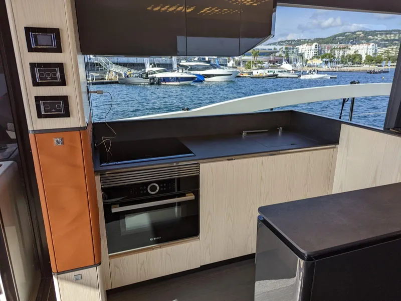 Slide: The Image of Modern kitchen interior on 2023 Astondoa 677 Coupe yacht with waterfront view. - 20