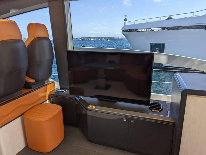 Slide: The Image of Luxurious interior of 2023 Astondoa 677 Coupe yacht with TV and leather seating. - 27