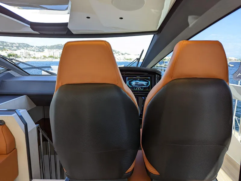 Slide: The Image of Interior view of 2023 Astondoa 677 Coupe yacht cockpit with leather seats. - 28