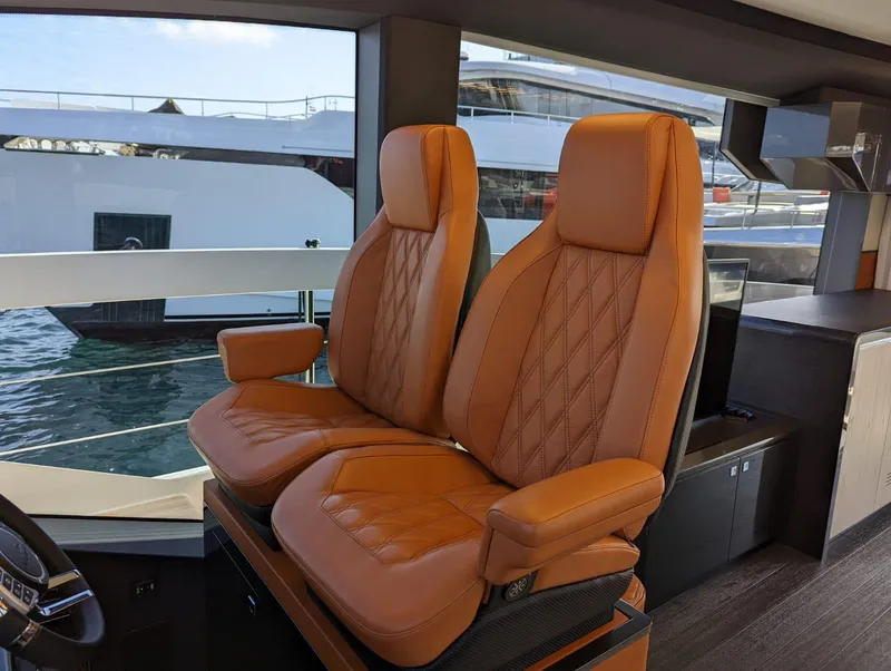 Slide: The Image of Luxurious leather seats inside 2023 Astondoa 677 Coupe yacht cockpit. - 30