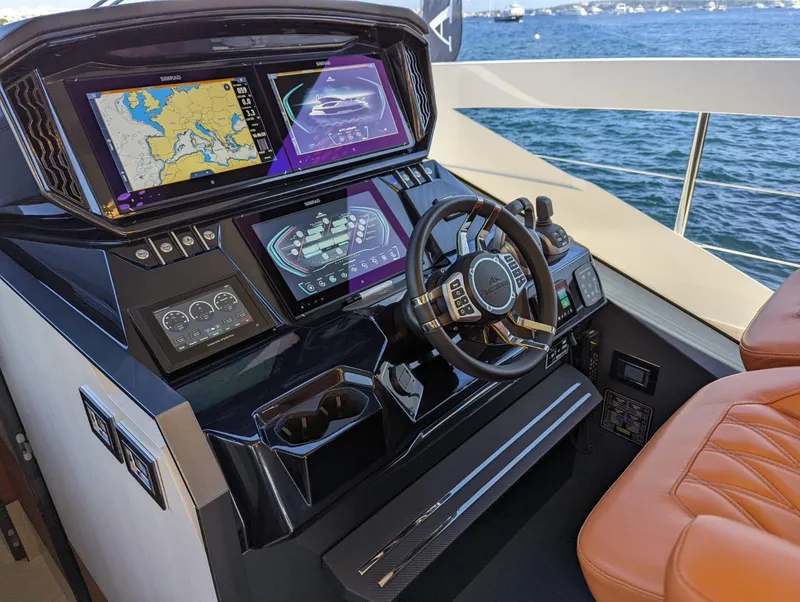 Slide: The Image of 2023 Astondoa 677 Coupe yacht helm with advanced navigation displays and luxurious seating. - 31