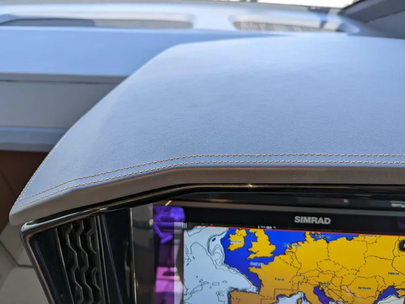 Slide: The Image of 2023 Astondoa 677 Coupe dashboard with Simrad navigation display. - 32