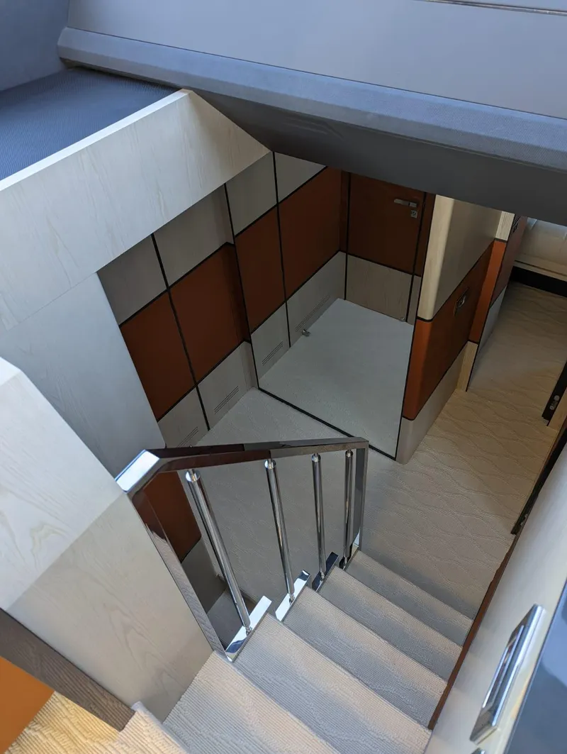 Slide: The Image of Interior staircase of 2023 Astondoa 677 Coupe yacht, featuring modern design and sleek finishes. - 33