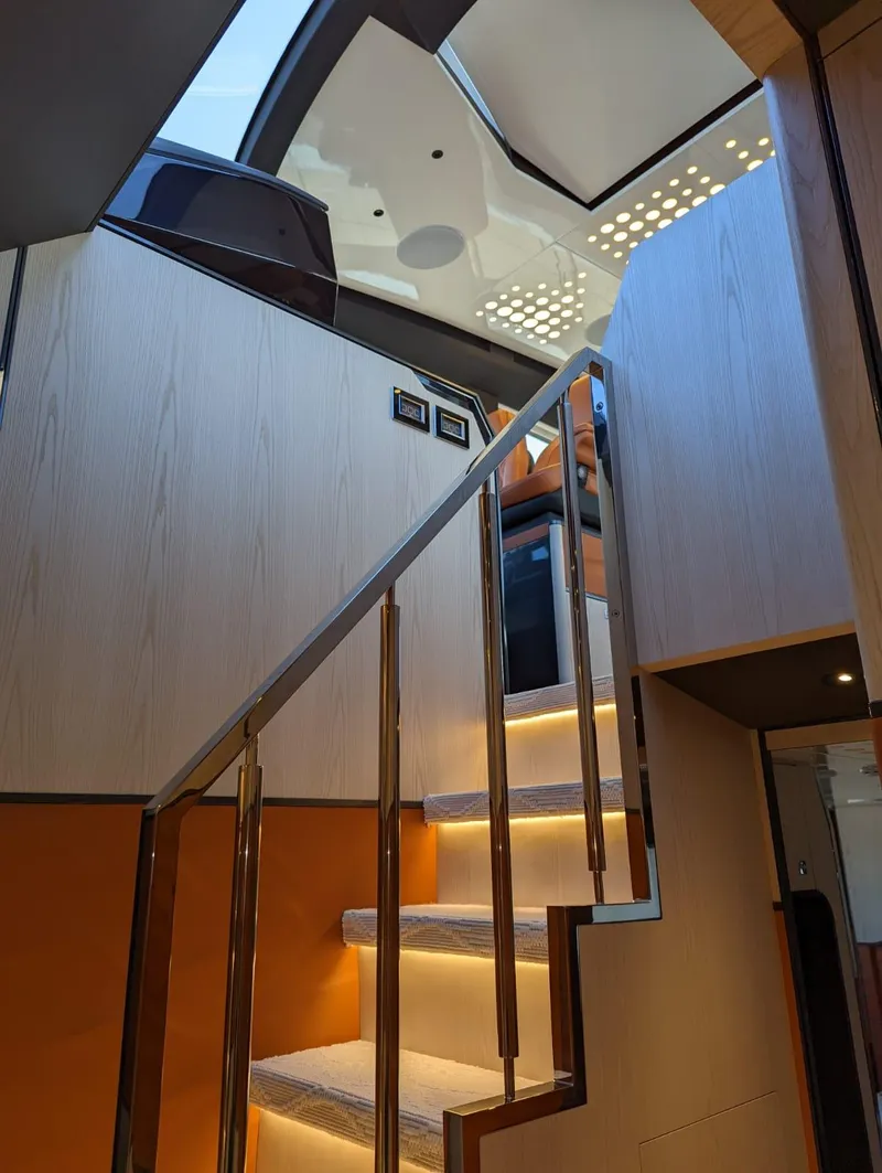Slide: The Image of Interior staircase of 2023 Astondoa 677 Coupe yacht with modern design and ambient lighting. - 34