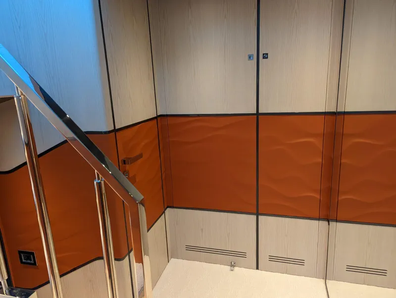 Slide: The Image of Interior of 2023 Astondoa 677 Coupe yacht with modern design and wood paneling. - 35
