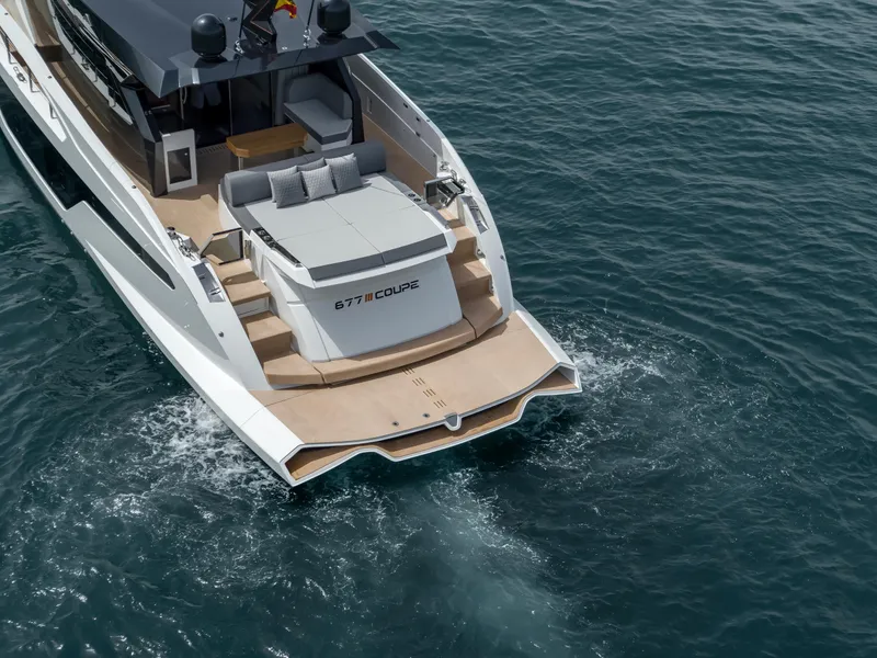 Slide: The Image of Astondoa 677 Coupe 2023 yacht cruising on open water, rear view. - 4