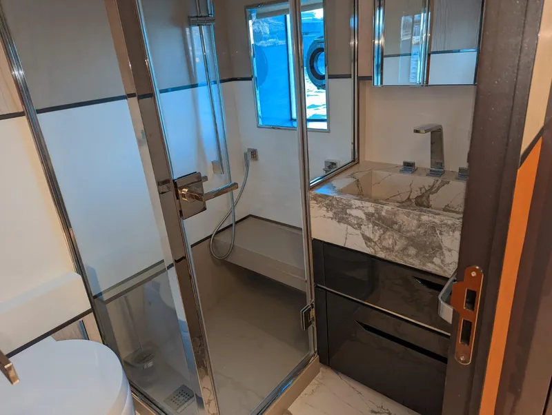 Slide: The Image of Luxurious bathroom in 2023 Astondoa 677 Coupe yacht with modern fixtures and marble sink. - 44