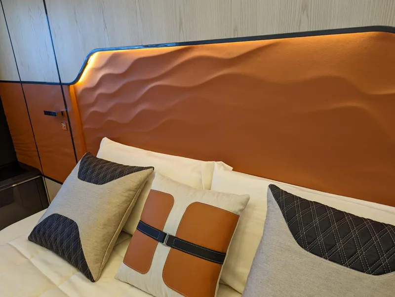 Slide: The Image of Luxurious interior of 2023 Astondoa 677 Coupe with elegant pillows and textured headboard. - 48