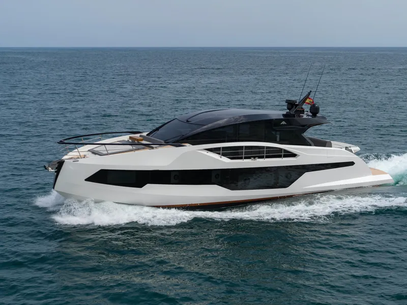 Slide: The Image of 2023 Astondoa 677 Coupe yacht cruising on open water. - 9