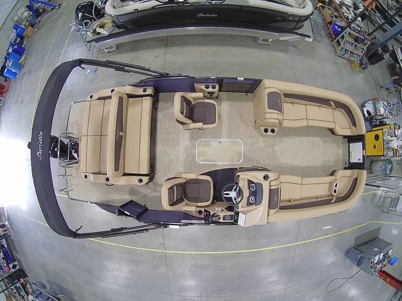 Slide: The Image of 2023 Barletta Cabrio 24UC pontoon boat interior, top view in a workshop. - 1