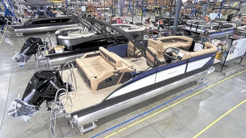 Slide: The Image of 2023 Barletta Cabrio 24UC pontoon boat in a showroom. - 2