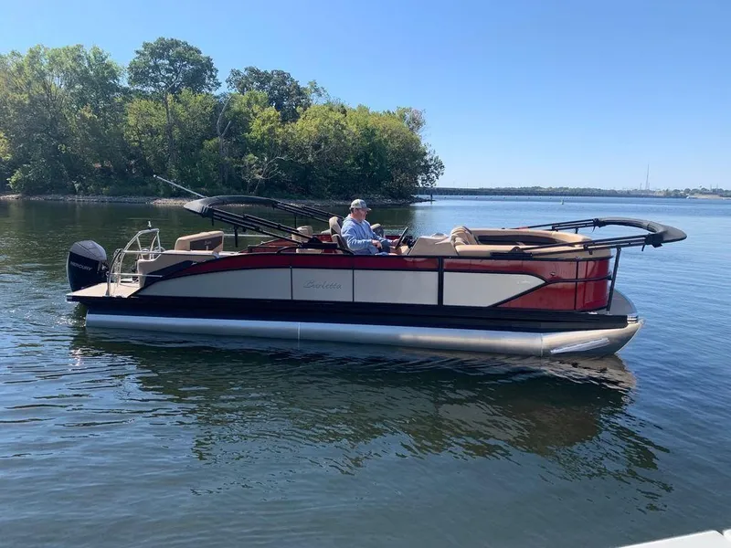 Slide: The Image of 2023 Barletta Cabrio 24UE pontoon boat on a calm lake. - 1