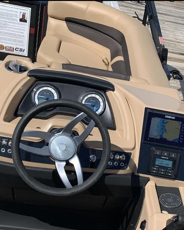 Slide: The Image of 2023 Barletta Cabrio 24UE boat dashboard with steering wheel and navigation system. - 10