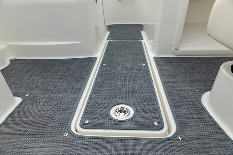 Slide: The Image of 2023 Bayliner VR4 OB boat interior with textured flooring and storage compartment. - 10
