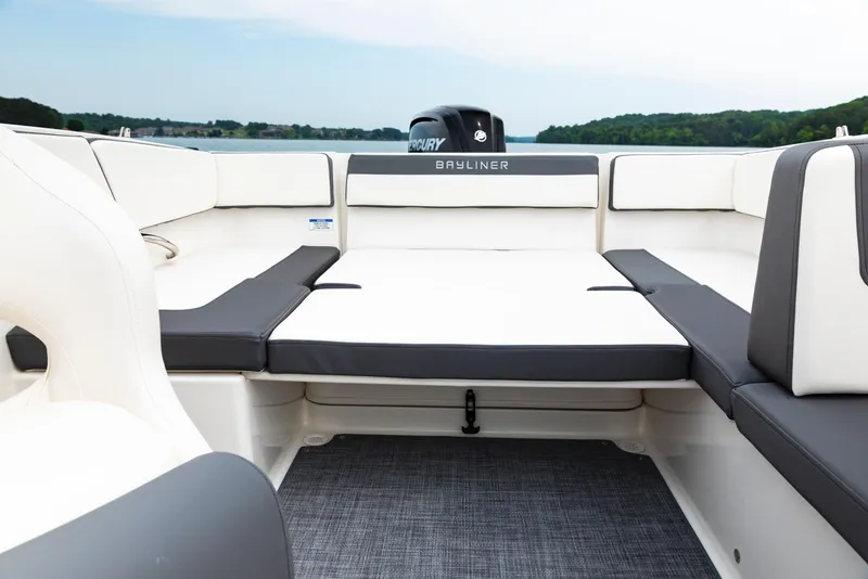 Slide: The Image of 2023 Bayliner VR4 OB boat interior with cushioned seating and Mercury outboard motor. - 14