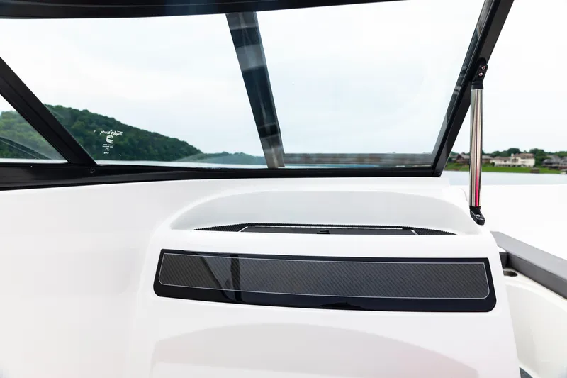 Slide: The Image of 2023 Bayliner VR4 OB boat dashboard with windshield, featuring sleek design and scenic background. - 19