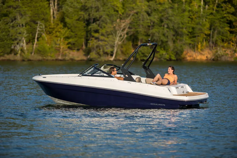 Slide: The Image of 2023 Bayliner VR4 OB boat cruising on a serene lake with two passengers. - 27