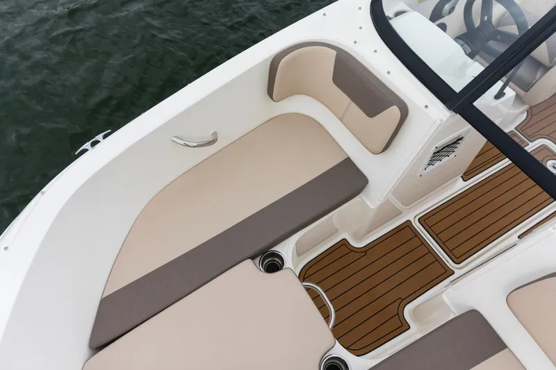 Slide: The Image of 2023 Bayliner VR4 OB boat interior with beige seating and wood-style flooring. - 32