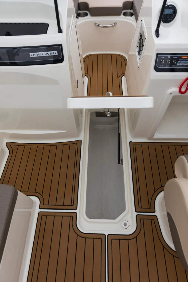 Slide: The Image of 2023 Bayliner VR4 OB boat interior with teak-style flooring and modern controls. - 43