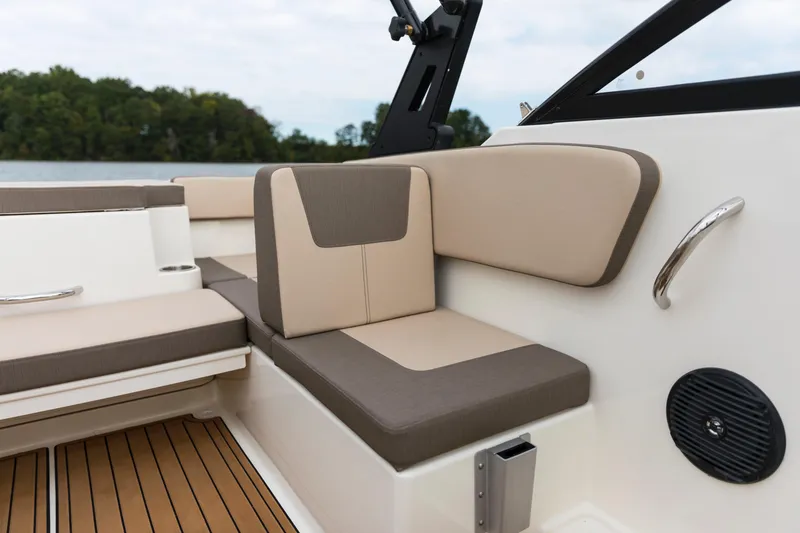 Slide: The Image of 2023 Bayliner VR4 OB boat interior with beige and brown seating, wood-style flooring. - 44