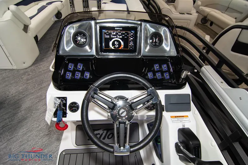 Slide: The Image of Control panel of a 2022 JC NEPTOON 25 TT SPORT boat with steering wheel and dashboard. - 25
