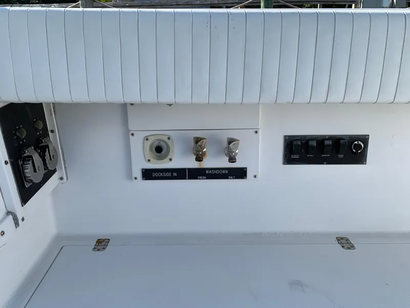 Slide: The Image of Control panel on a 1997 Phoenix 38 SFX Convertible boat, featuring dockside and washdown controls. - 11
