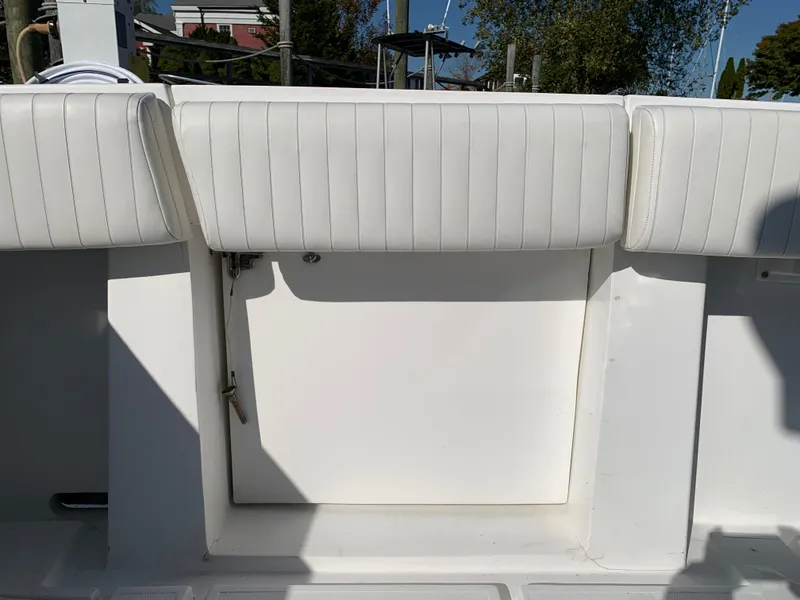 Slide: The Image of 1997 Phoenix 38 SFX Convertible boat with white cushioned seating and storage compartment. - 12