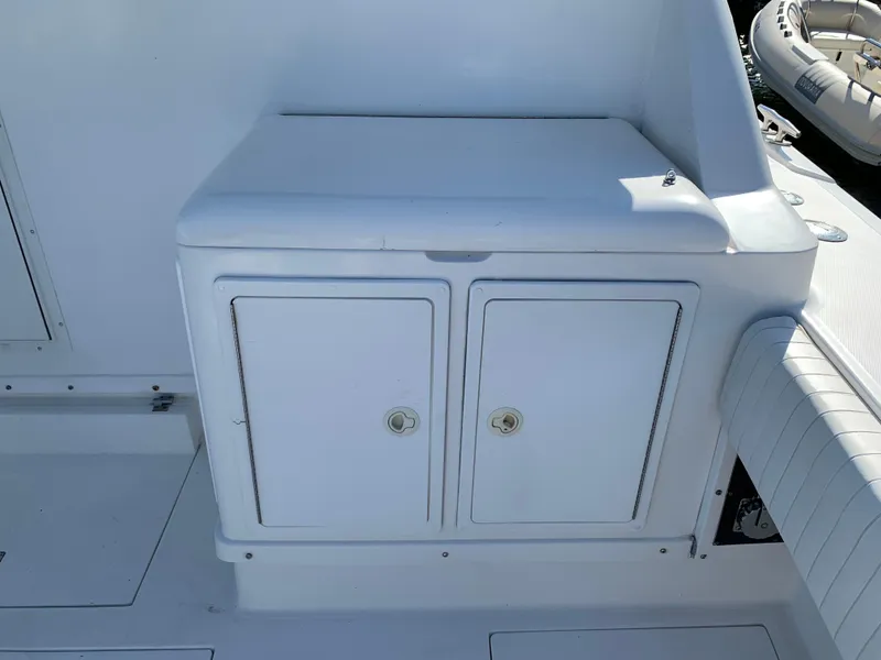 Slide: The Image of White storage compartment on a 1997 Phoenix 38 SFX Convertible boat deck. - 13