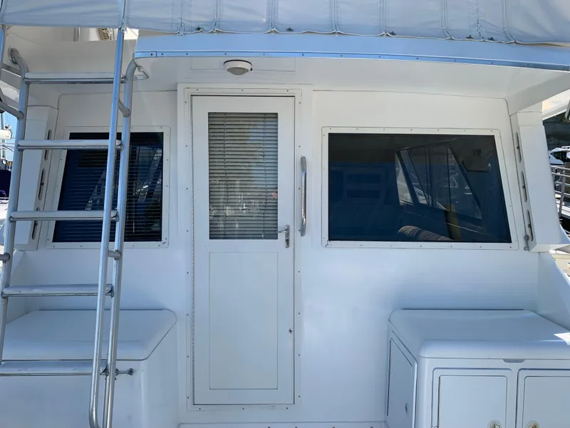 Slide: The Image of 1997 Phoenix 38 SFX Convertible yacht with ladder and cabin door. - 15