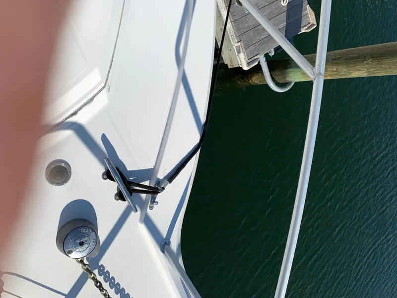 Slide: The Image of Bow of 1997 Phoenix 38 SFX Convertible yacht docked at marina. - 19