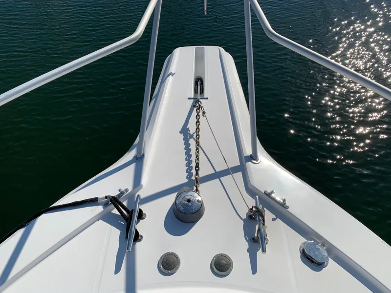 Slide: The Image of Bow of 1997 Phoenix 38 SFX Convertible boat with anchor chain, on sparkling water. - 20