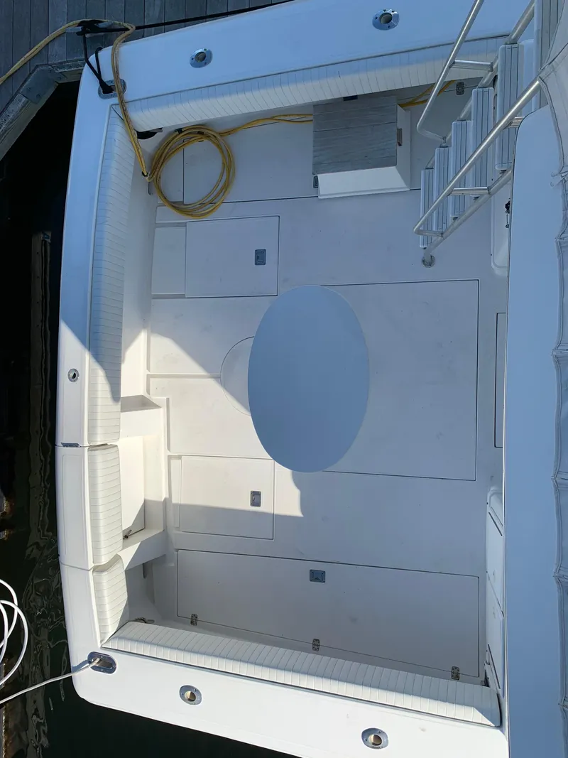 Slide: The Image of 1997 Phoenix 38 SFX Convertible boat deck with seating and storage compartments. - 27