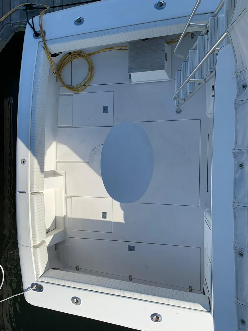 Slide: The Image of 1997 Phoenix 38 SFX Convertible boat deck with seating and storage compartments. - 28