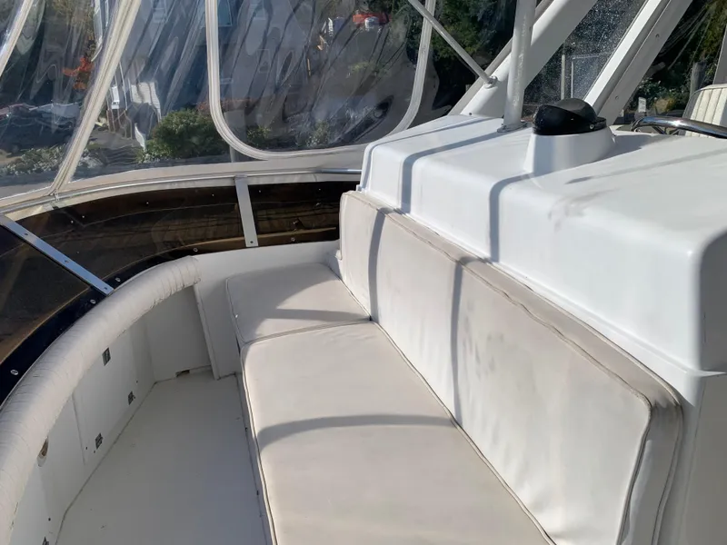 Slide: The Image of 1997 Phoenix 38 SFX Convertible boat interior with white seating and clear windows. - 33
