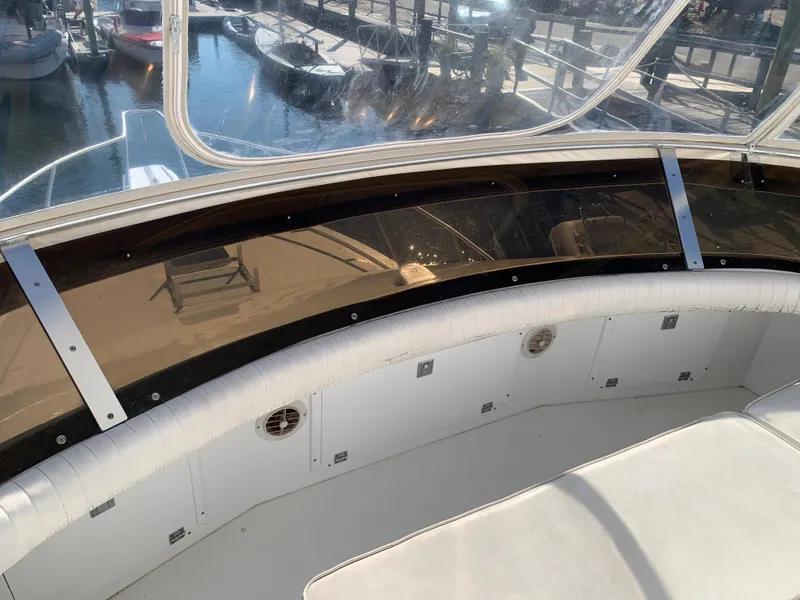 Slide: The Image of 1997 Phoenix 38 SFX Convertible boat interior with marina view through windows. - 36