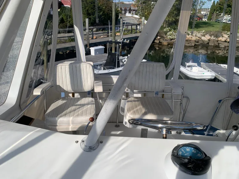 Slide: The Image of 1997 Phoenix 38 SFX Convertible boat interior with helm and seating area. - 37