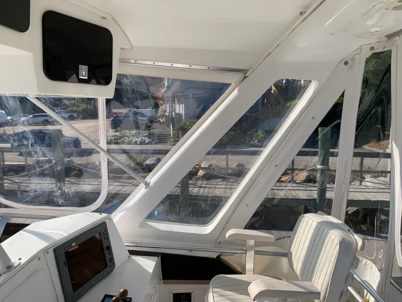 Slide: The Image of Interior view of 1997 Phoenix 38 SFX Convertible boat with helm and seating. - 39