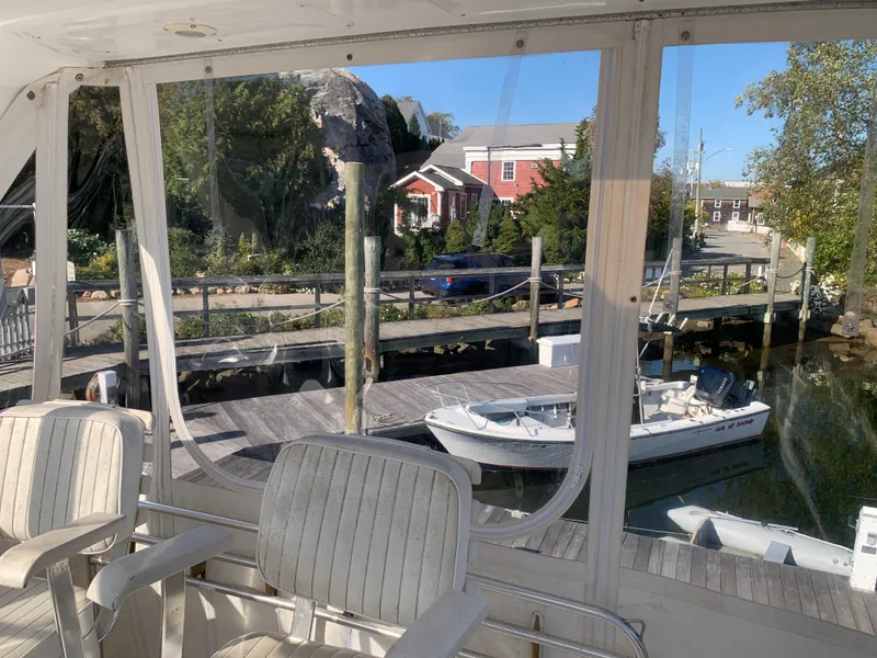 Slide: The Image of View from a 1997 Phoenix 38 SFX Convertible, overlooking a docked boat and waterfront scenery. - 40