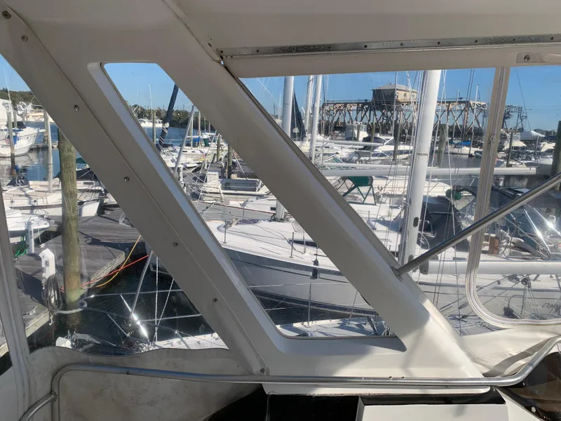 Slide: The Image of View from 1997 Phoenix 38 SFX Convertible, overlooking marina with sailboats and clear blue sky. - 41