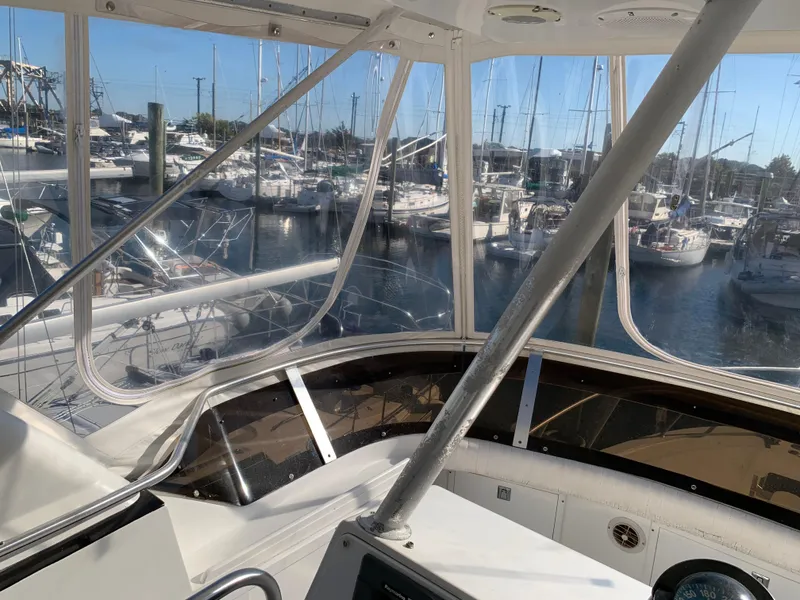 Slide: The Image of Interior view of a 1997 Phoenix 38 SFX Convertible yacht at a marina. - 42