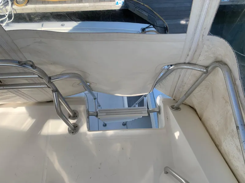 Slide: The Image of Stainless steel ladder on 1997 Phoenix 38 SFX Convertible boat deck. - 43