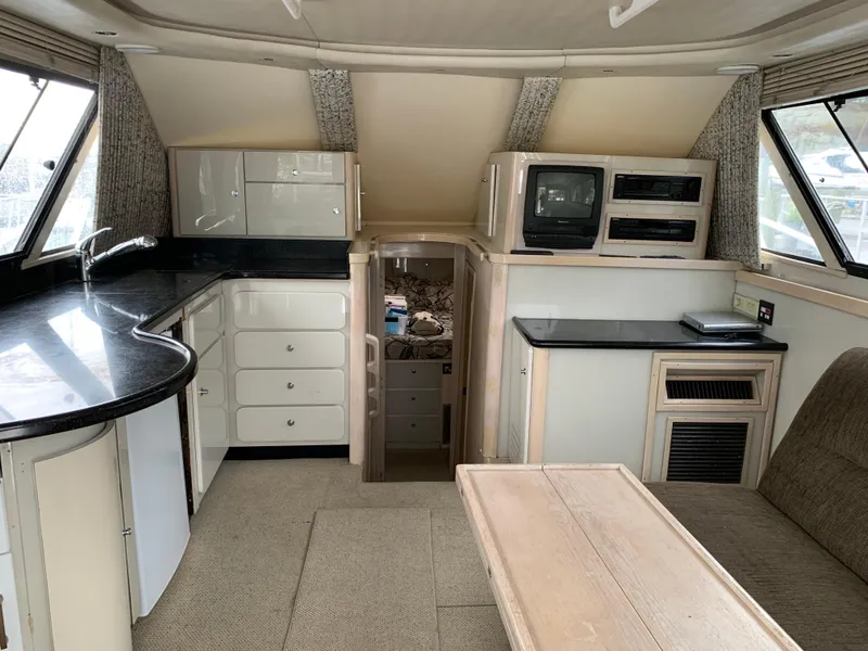 Slide: The Image of Interior of 1997 Phoenix 38 SFX Convertible yacht with kitchen and lounge area. - 44