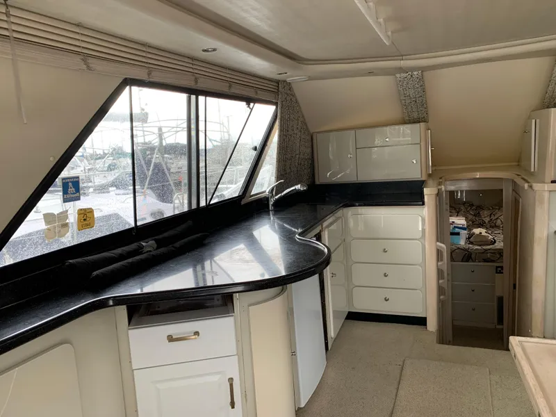 Slide: The Image of Interior of 1997 Phoenix 38 SFX Convertible yacht with modern kitchen and sleek design. - 45