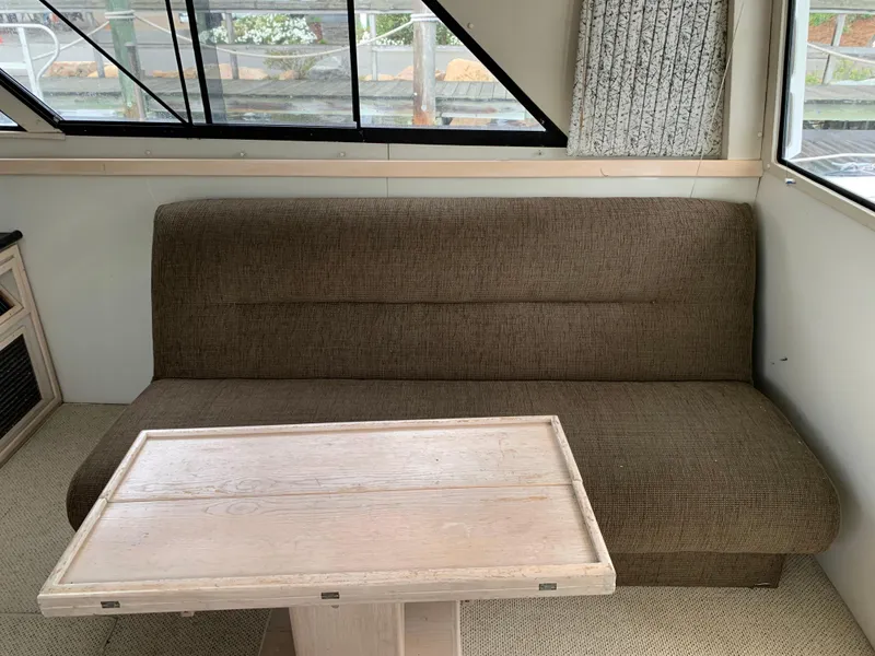 Slide: The Image of Brown sofa and wooden table inside 1997 Phoenix 38 SFX Convertible boat. - 47