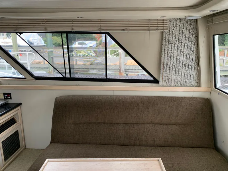 Slide: The Image of Interior of 1997 Phoenix 38 SFX Convertible with brown sofa and large windows. - 48