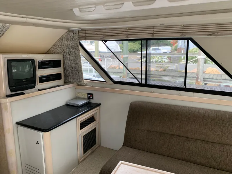 Slide: The Image of Interior of 1997 Phoenix 38 SFX Convertible yacht with TV and seating area. - 49