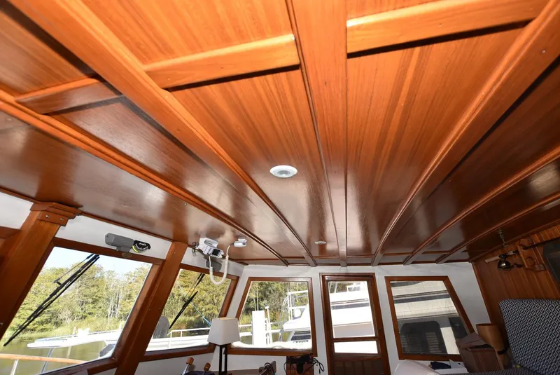 Slide: The Image of 1983 Krogen Trawler interior with wooden ceiling and large windows. - 15