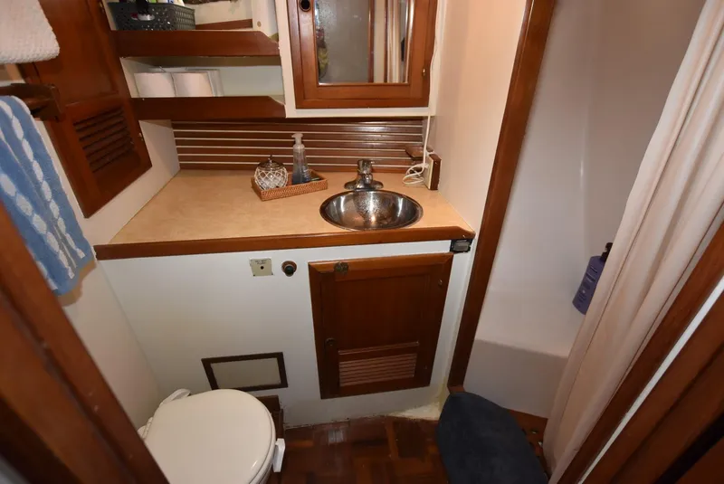 Slide: The Image of 1983 Krogen Trawler bathroom with sink, toilet, and shower. - 29