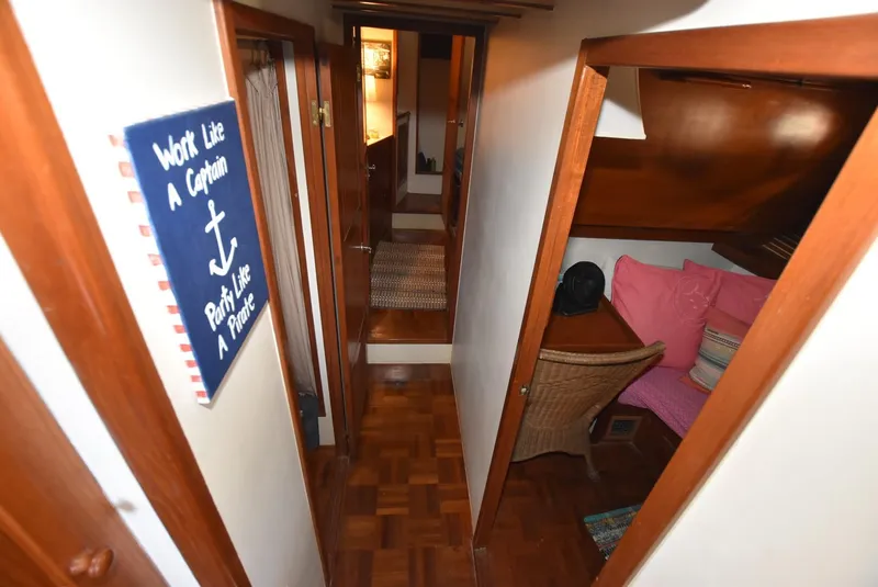 Slide: The Image of 1983 Krogen Trawler interior with wood paneling, cozy seating, and nautical decor. - 30