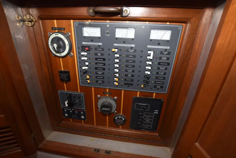 Slide: The Image of Electrical control panel on a 1983 Krogen Trawler, featuring gauges and switches. - 31
